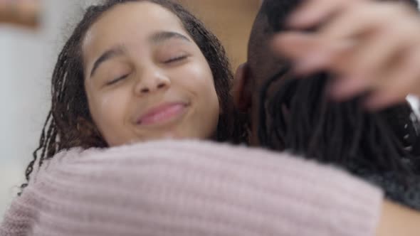 Closeup Portrait of Happy African American Teen Girl Hugging Man Smiling Looking at Camera