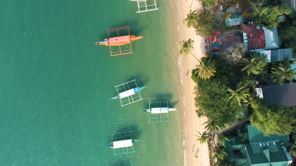 Top Drone View of a Traditional Philippine Boats on the Surface of the Azure Water in the Lagoon