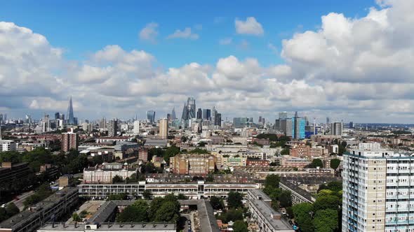 Aerial shot, sliding left to right panning down with the London skyline in the background