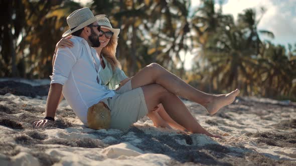 Couple Lies On Tropical Beach. Lovers On Vacation. Couple On Summer Beach Near Ocean.