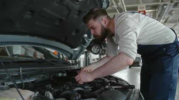 Mechanic Doing Routine Maintenance alt