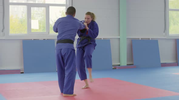 Woman Practicing Jujitsu with Male Partner