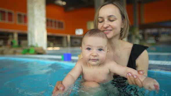 Mother Teaches Her Baby to Swim in a Closed Public Pool