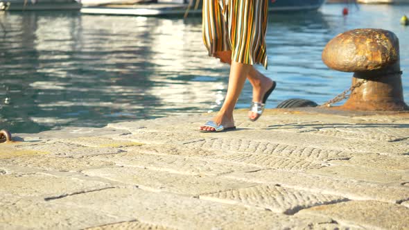 Close-up of a woman feet and legs walking in Portofino, Italy, a luxury resort town in Europe.