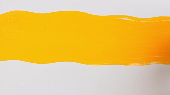 Abstract Brushstrokes of Yellow Paint Brush Applied Isolated on a White Background