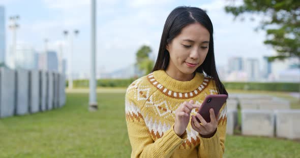 Woman work on mobile phone in city