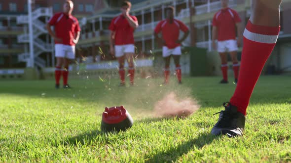 Rugby player kicking the ball from the kicking tee in the stadium 4k