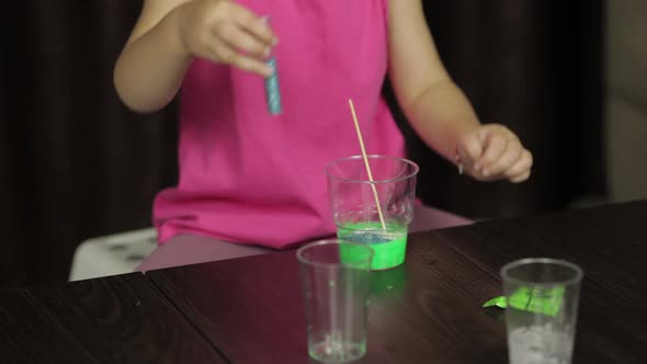 Child Hands Making Green Slime. Mixes Ingredients. Playing with Hand Made Toy