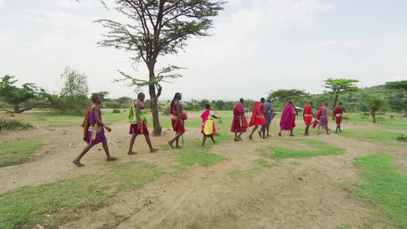 Maasai people walking in a row