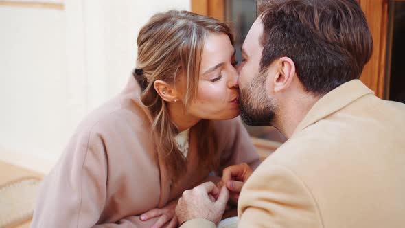 Lovely couple talking and kissing in cafe alt