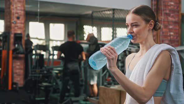 Closeup Portrait of a Caucasian Millennial Gorgeous Girl Opening a Water Bottle and Relaxing After