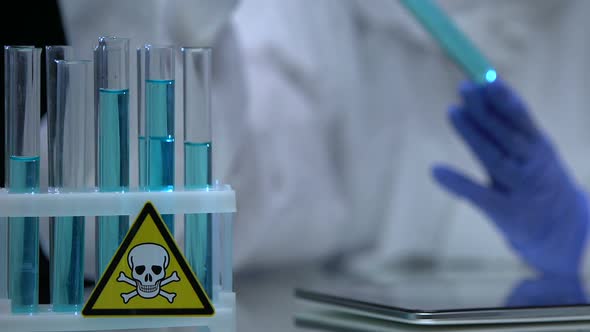 Researcher Putting Poisonous Liquid in Tube Rack, Secret Laboratory Experiment