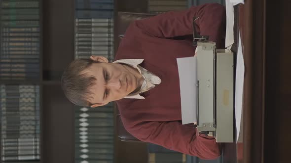 Male Writer Using Typewriter for Work