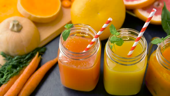 Close Up of Fresh Juices in Mason Jar Glasses 