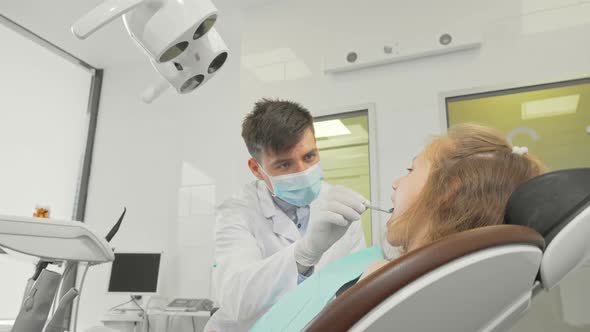 Charming Little Girl Smiling Showing Thumbs Up After Dental Checkup