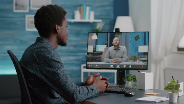 Selective Focus on Black Guy Using Online Conference Video Call Talking with His Work Colleague