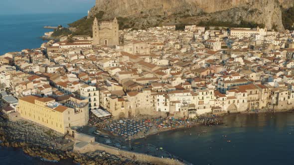 Flying over Cefalu during sunset in Island of Sicily Italy 4K