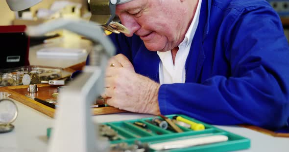 Horologist repairing a watch