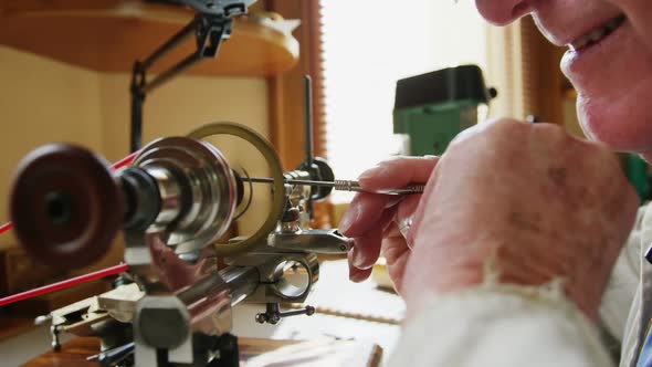 Horologist using a machine