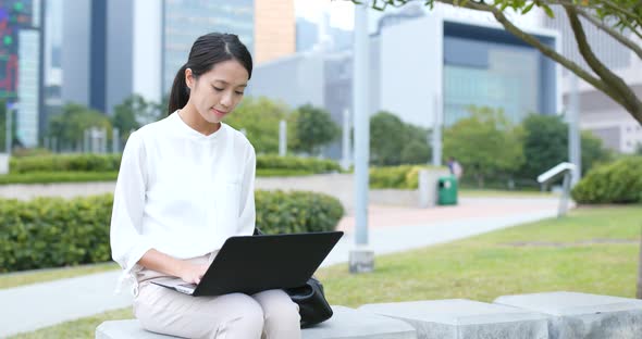 Woman use of laptop computer at outdoor