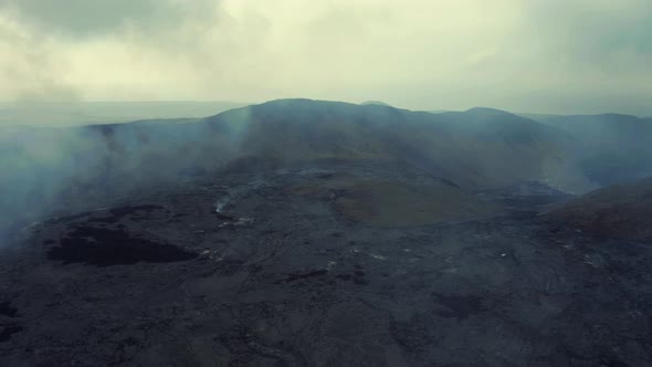 Volcano Smoke Rising From The Ground. Lava Field After Volcanic Eruption. drone forward