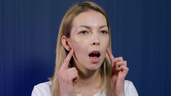 Female Trainer of Facial Gymnastics Is Showing Exercise for Beauty of Face, Closeup Portrait