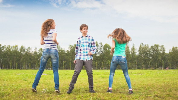 Teens Dancing in Meadow