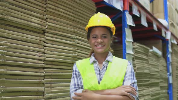 Portrait of African-american female worker wearing reflective safety vest with smile, look at camera