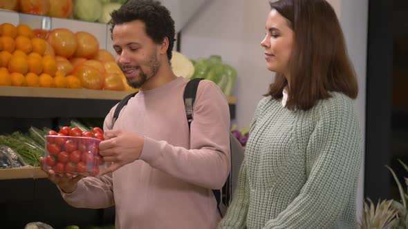 Pleased Couple Choosing Tomatoes in Supermarket