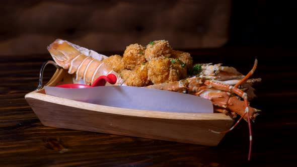 Cooked Lobster Dinner Served on Wooden Table in Restaurant