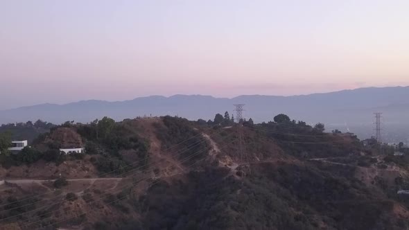 AERIAL: Over Hollywood Hills at Sunrise with View on Hills and the Valley in Los Angeles View 