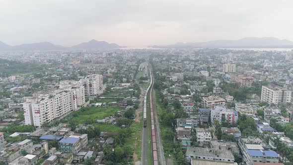 Great suburb neighborhood of town divided by railway where trains driving through, to transport pass