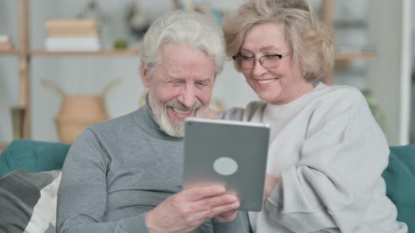 Loving Old Couple Using Tablet Together at Home