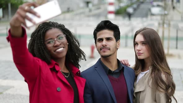 Two Women and Man Making Selfie Outside, Posing, Smiling