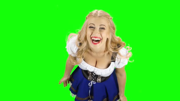 Woman in Bavarian National Costume Laughs. Green Screen