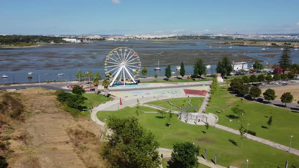 Aerial View Of Ferris Wheel At Quinta dos Franceses Park With River In Background In Seixal City, Po