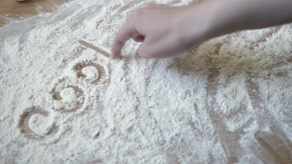 Cooking Inscription Made of Flour on the Table