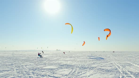 Kite surfers training on the ice of a frozen lake in Siberia.