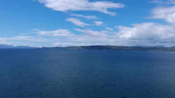 Push-down drone tilt shot of ocean view. Aerial video shot by a drone. Mallaig, Scotland, Isle of Sk