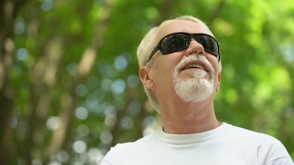 Visually Impaired Man in Sunglasses Listening Nature Sounds, Heightened Senses