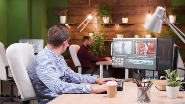 Multimedia Manager in the Office Talking with His Assistant