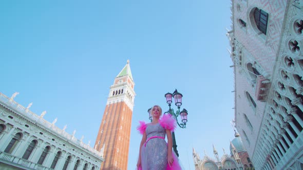 Blonde Girl in the Pink Dress in Venice in Front of the San Marco Bell Tower