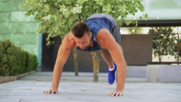 Young Man Doing Push Ups on City Street