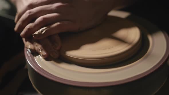 Artisan Hands Forming a Plate From Clay on a Potter's Wheel in Slow Motion