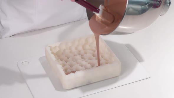 Pastry Chef Pours the Brown Cream Into a Silicone Cake Mold