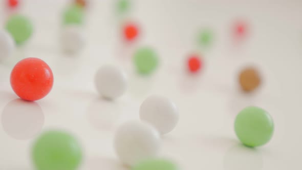 Abstract colorful background made of round candy bonbon on white 4K 2160p UltraHD  pan footage - Lot