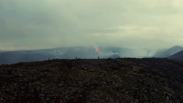 Distant View Of Volcanic Eruption Disaster With People Watching From Afar. aerial