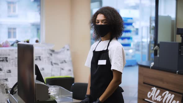 Portrait of an African American Worker at Grocery Store Checkout Wearing Mask