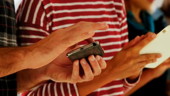 Group of colleagues using electronic devices