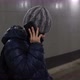 Lonely Boy in Hat and Jacket Talking on Phone in Underground Covered Passage in City in Winter - VideoHive Item for Sale